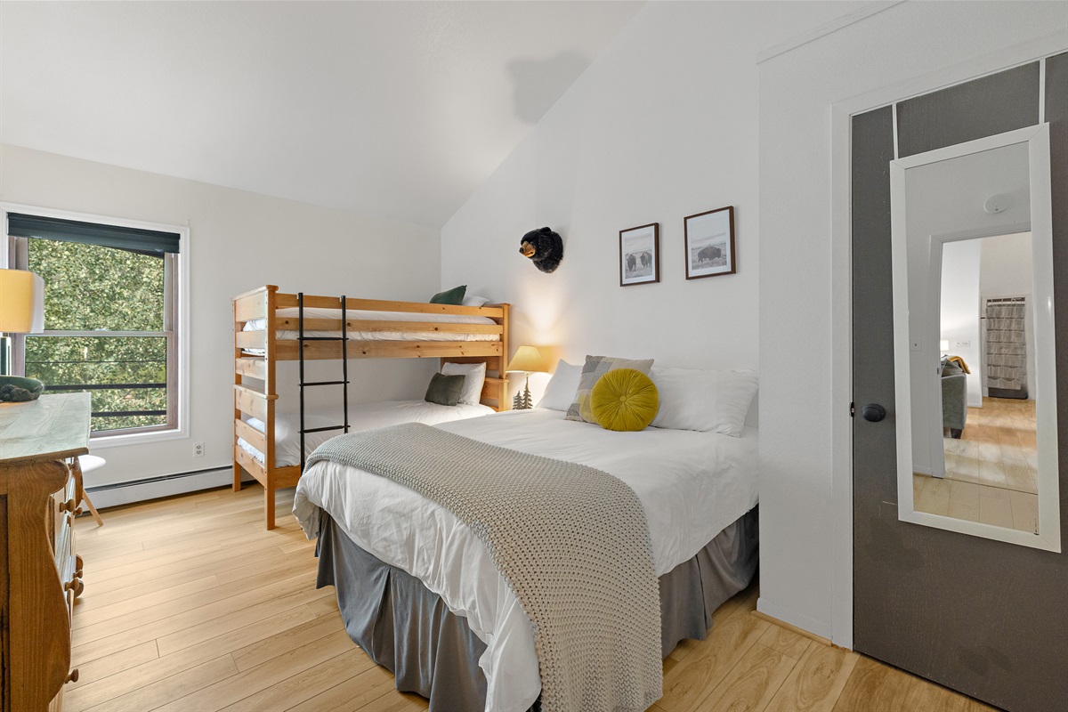 Bedroom 2, with one queen bed, one twin bunk, and attached bathroom