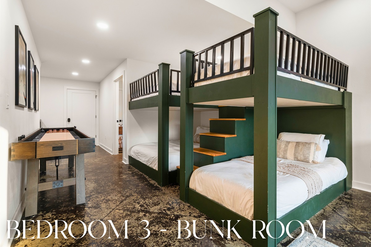 Bunk room featuring built-in beds and plenty of space for guests.