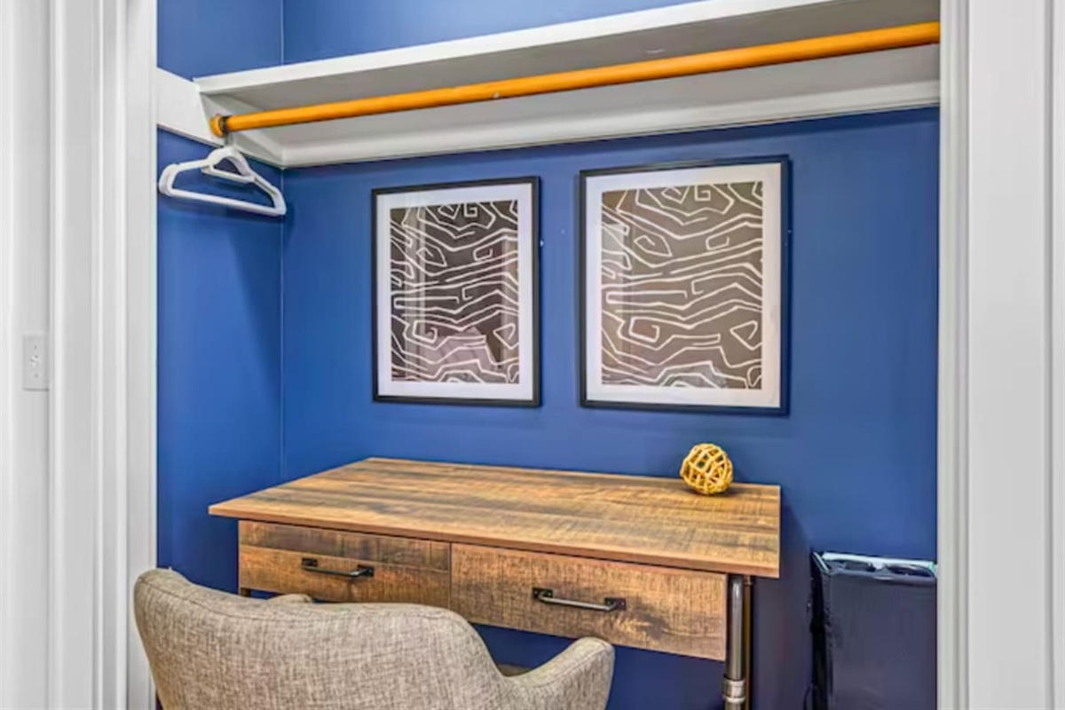 Dedicated Workspace in the Third Bedroom with Wood Desk and Chair