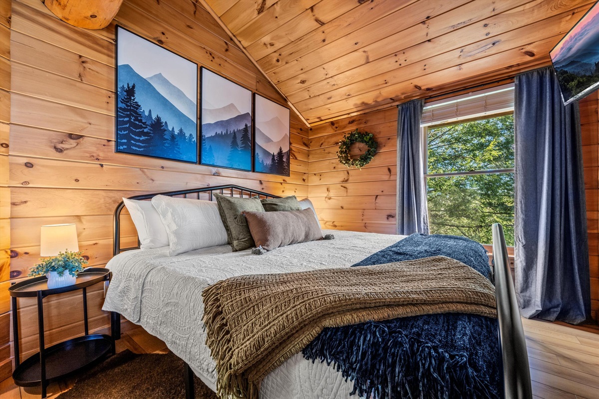 The upstairs King bedroom is cozy & has beautiful views.