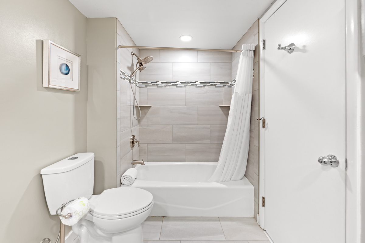 Main Bathroom with double sinks and tub/shower combo