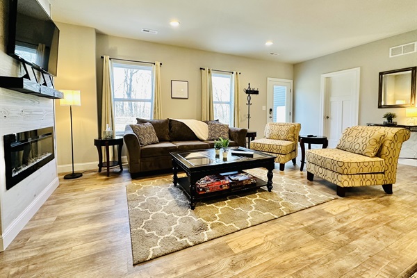 Living Room with built in electric fireplace, plenty of board games, and lots of natural light.