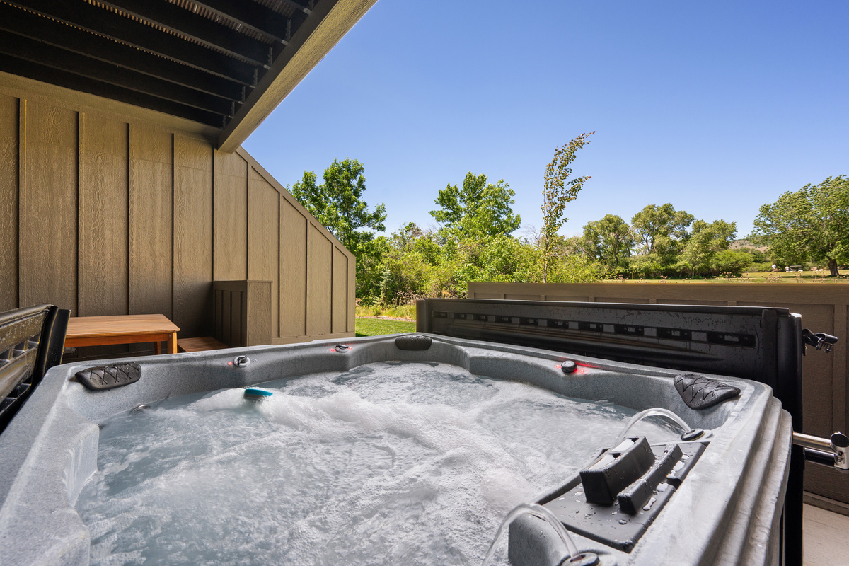 Relax in the bubbling hot tub while enjoying peaceful mountain valley views from this sheltered outdoor retreat.