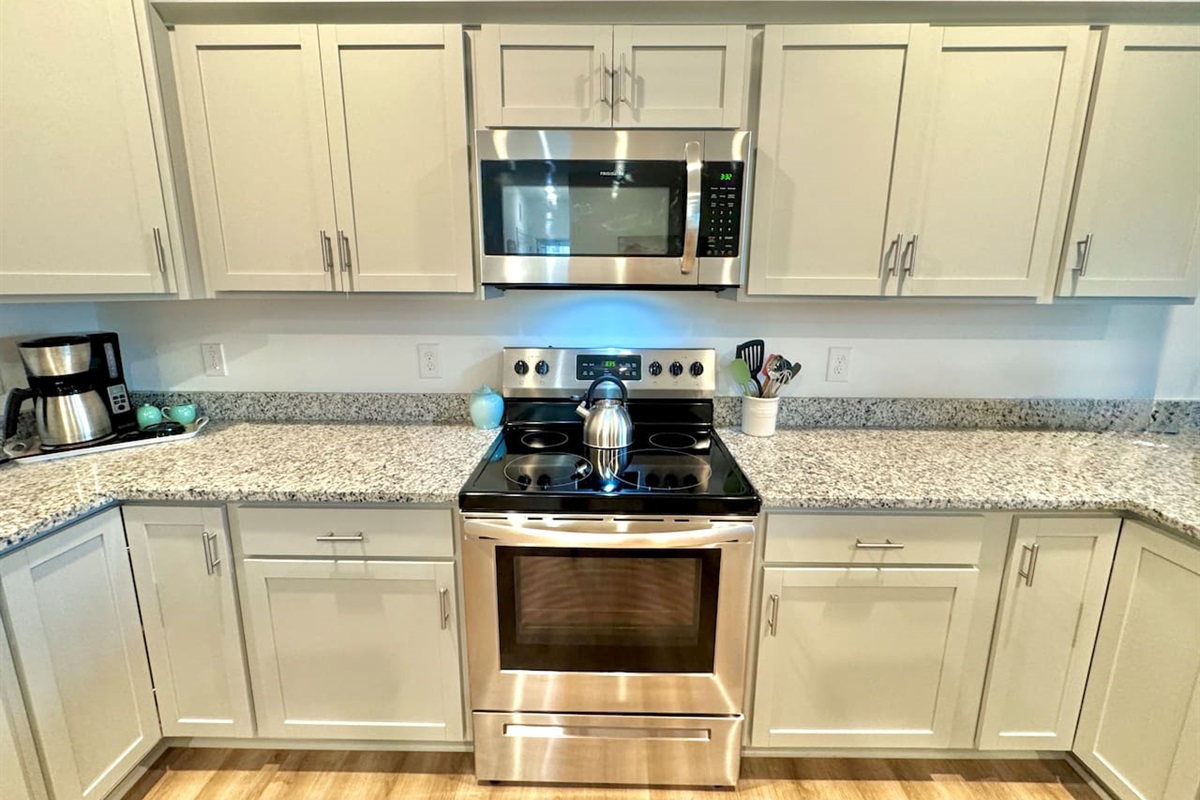 Enjoy cooking in this fully stocked kitchen with a custom island and ample bar seating. 