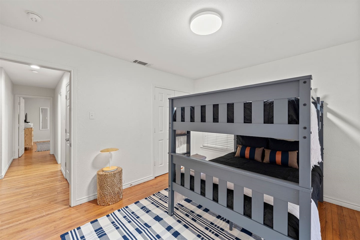 Ideal for families or groups, this bunk room offers a twin-over-full setup with cozy bedding and playful, modern vibes.