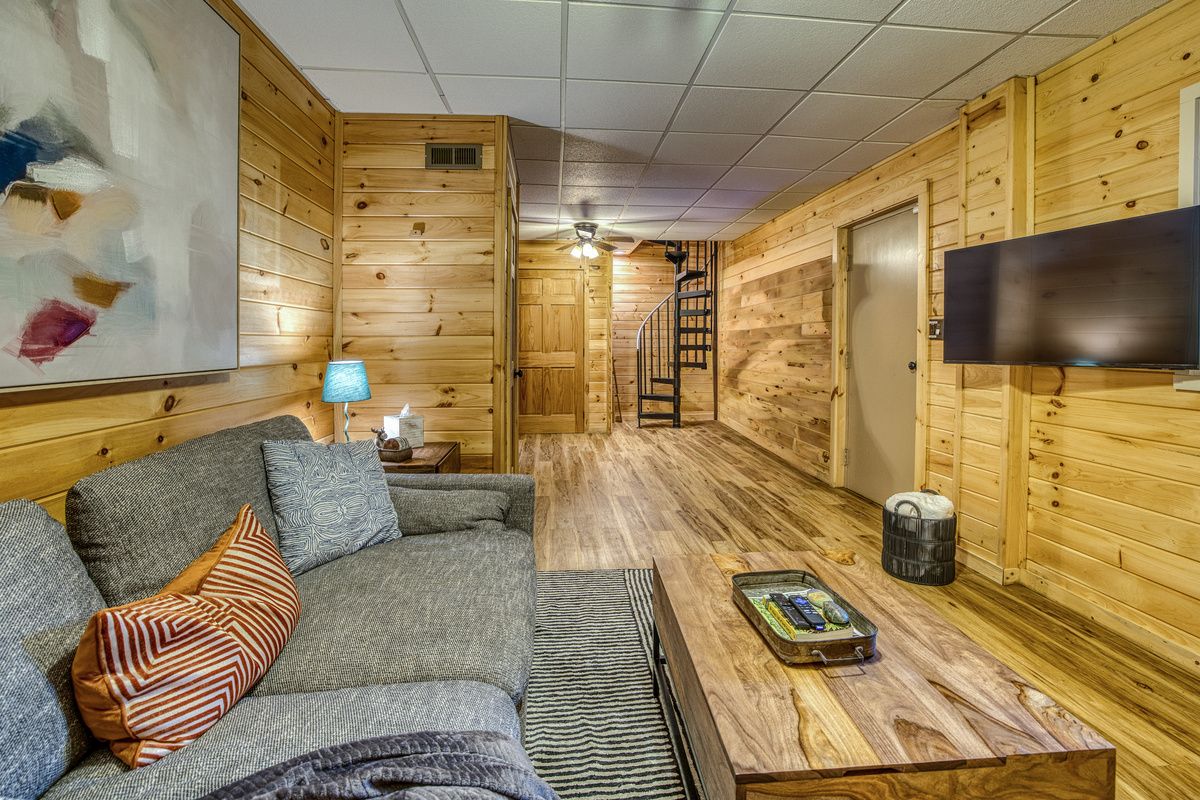 Living room with a sectional and TV.