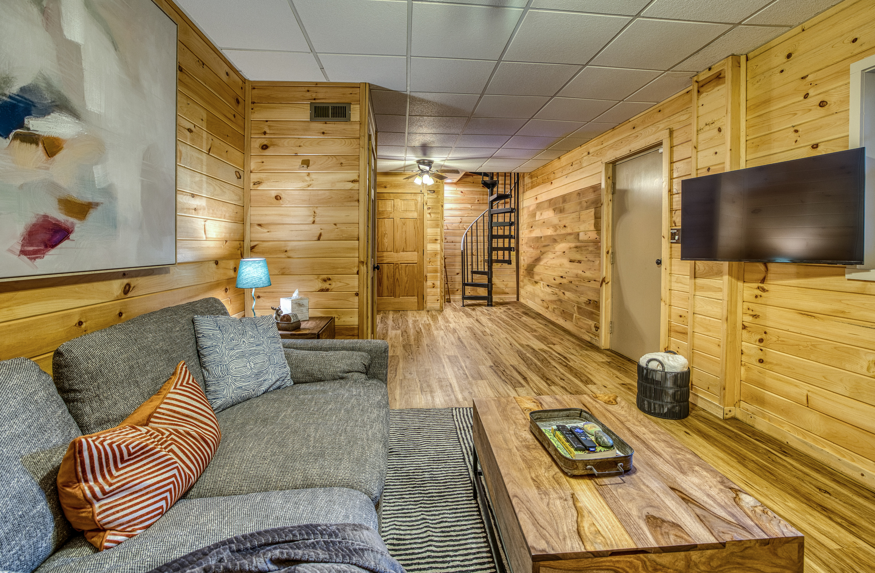 Living room with a sectional and TV.