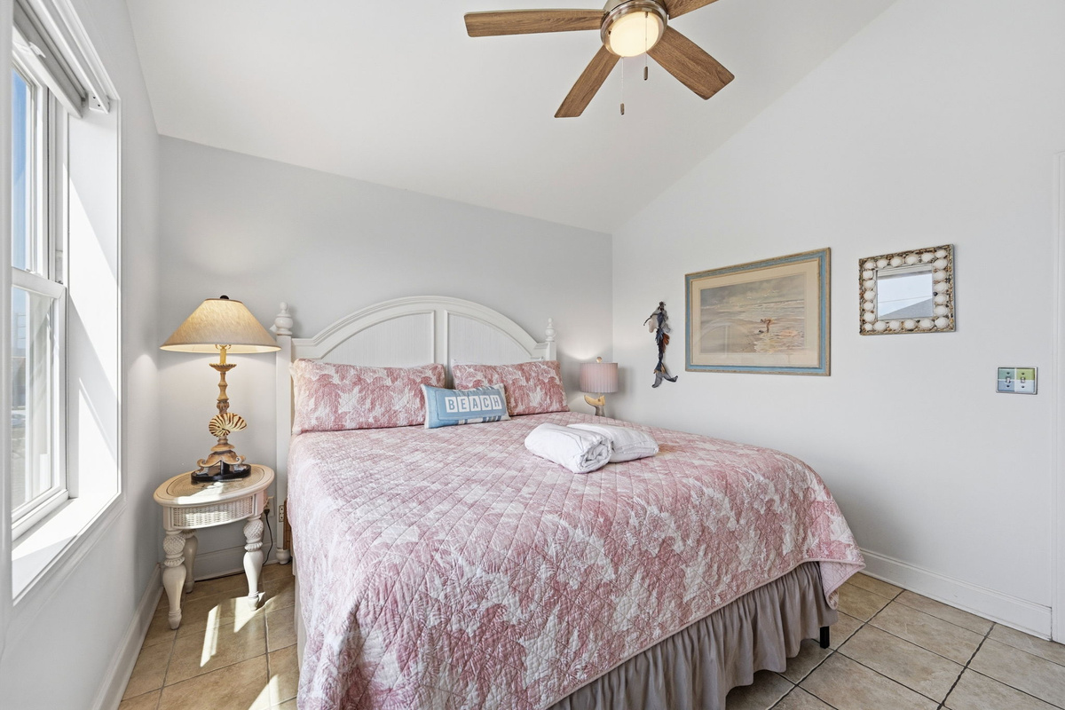 Second angle of the master bedroom, featuring coastal styling, bedside seating, and relaxed beach-inspired finishes