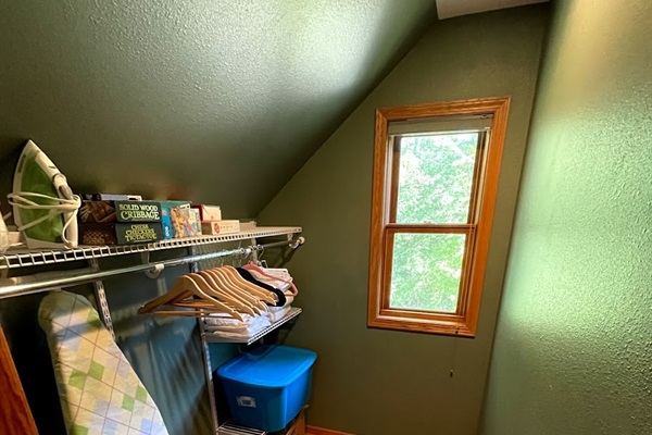 large walk in closet- hangers iron board games