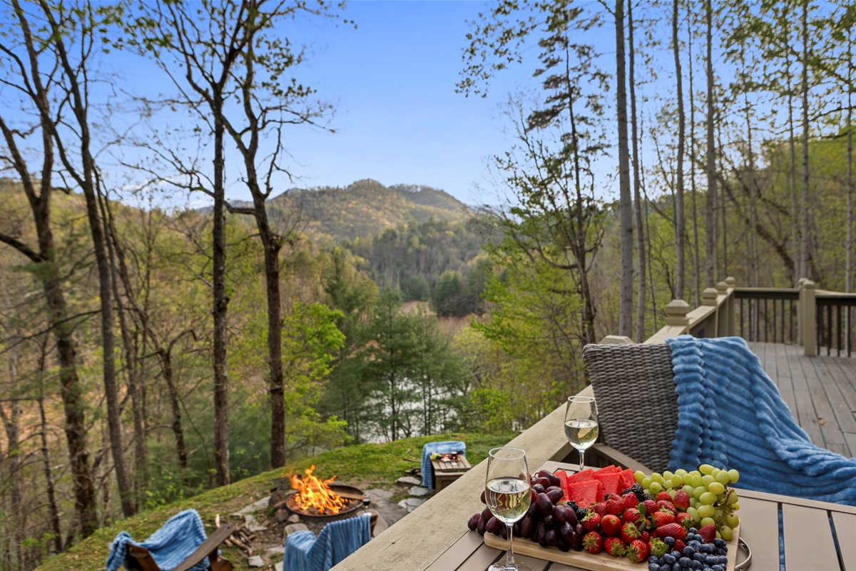 Deck Retreat: Savor gourmet bites and mountain views by the fire under endless blue skies!