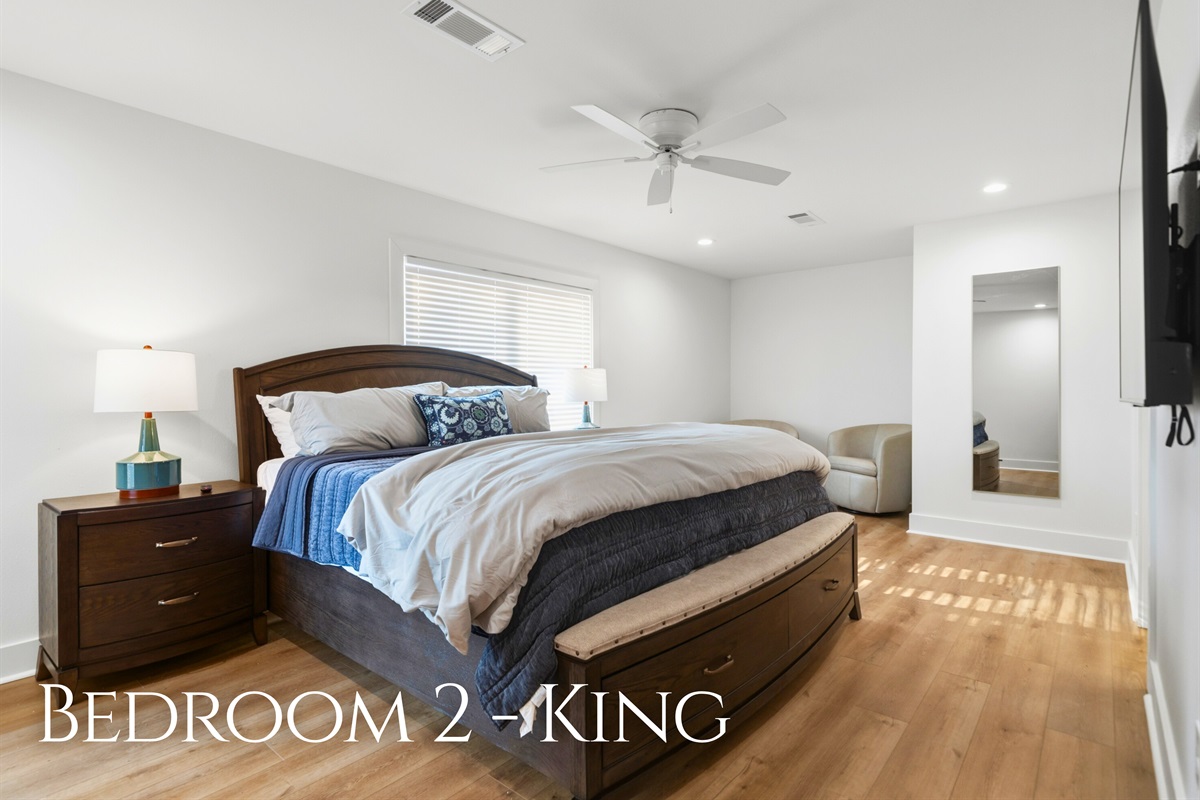 Calm tones and comfortable bedding create a relaxing atmosphere in this king bedroom, making it easy to unwind after a full day by the lake.