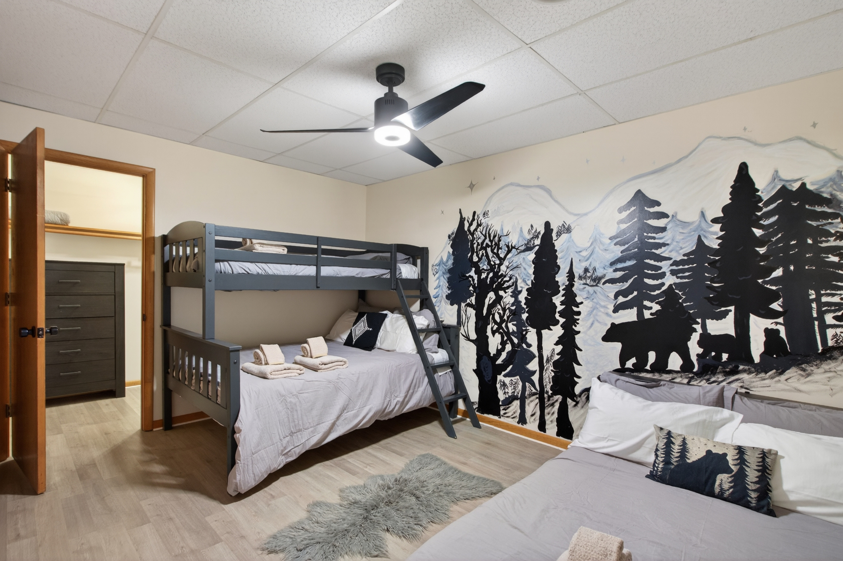 Bunk Bedroom 2: Adventure awaits in this themed suite with comfy beds and stunning nature mural!