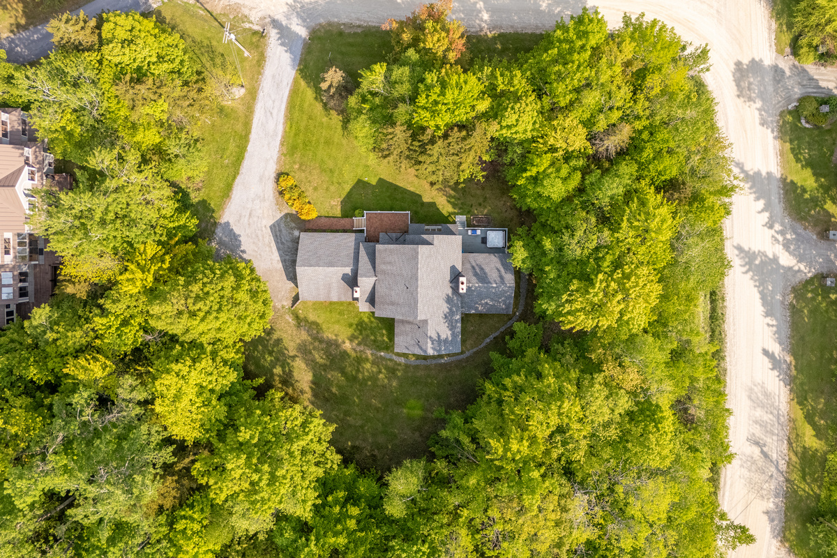 Overhead drone view of the private wooded lot and driveway at First Chair Lair near Stratton Mountain