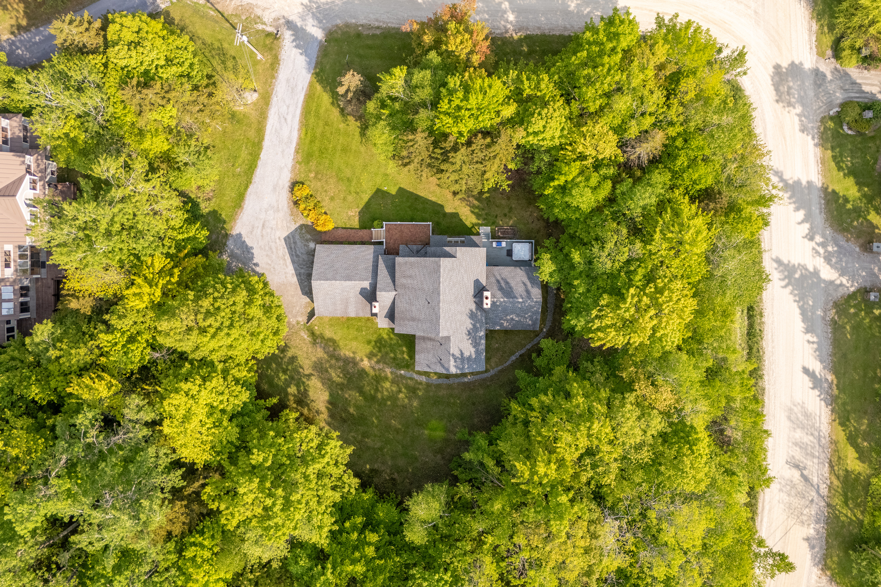 Overhead drone view of the private wooded lot and driveway at First Chair Lair near Stratton Mountain