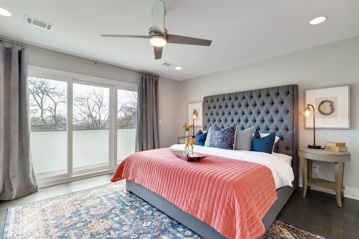 - Relax in a plush comfortable bed with a tufted headboard and luxe layered linens - Large sliding doors let in soft natural light and open to a private balcony - Pops of coral and deep blue add warmth and character to the calming decor