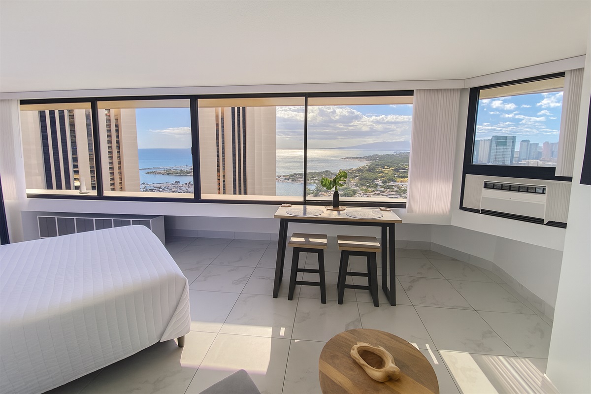 Wake up to panoramic ocean and harbor views stretching across the Honolulu coastline. This elegant Waikīkī studio offers floor-to-ceiling windows, modern finishes, and the perfect space to enjoy breakfast with a view of paradise.