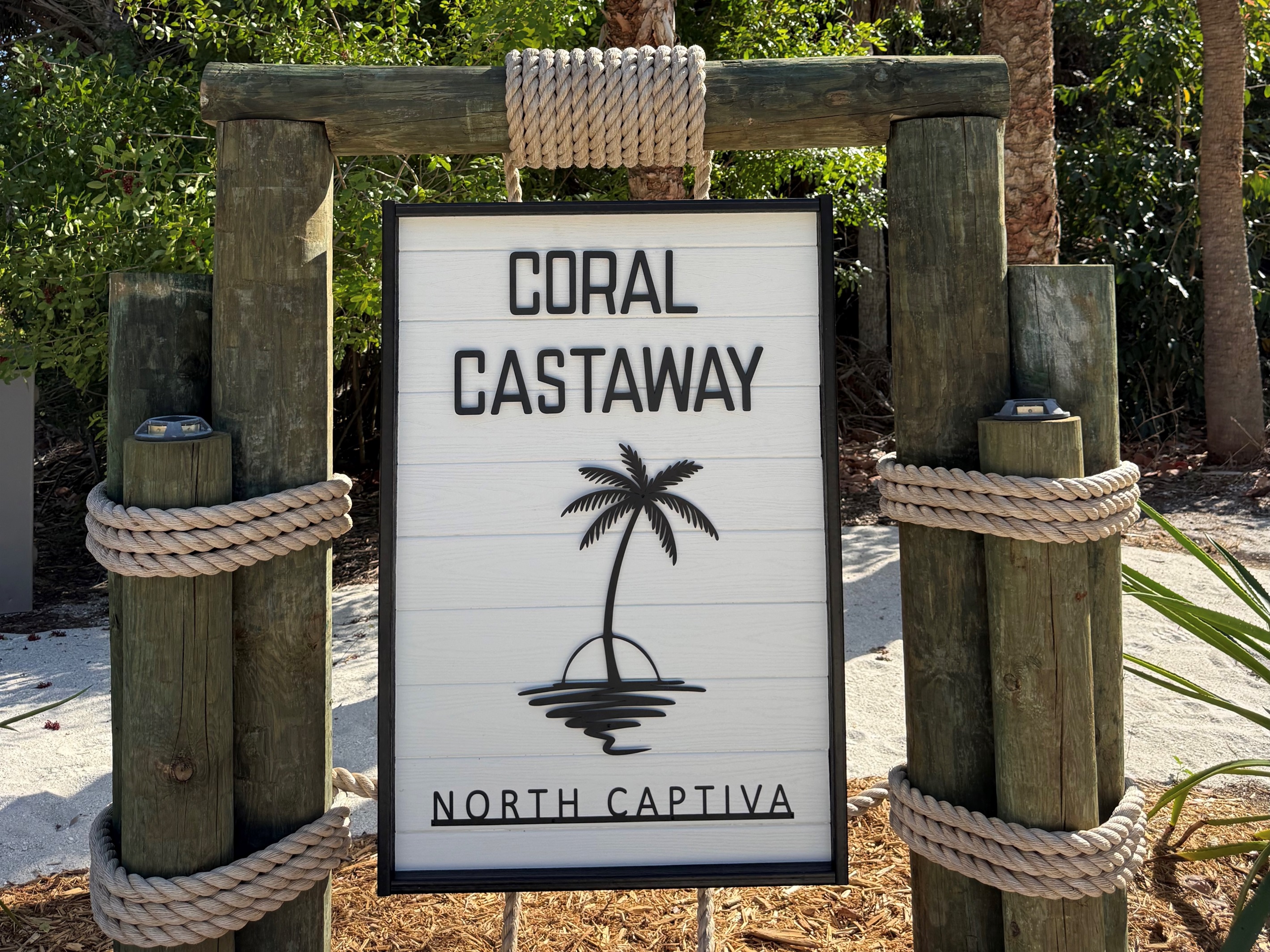 Let the Coral Castaway sign be your official invitation to make yourself at home