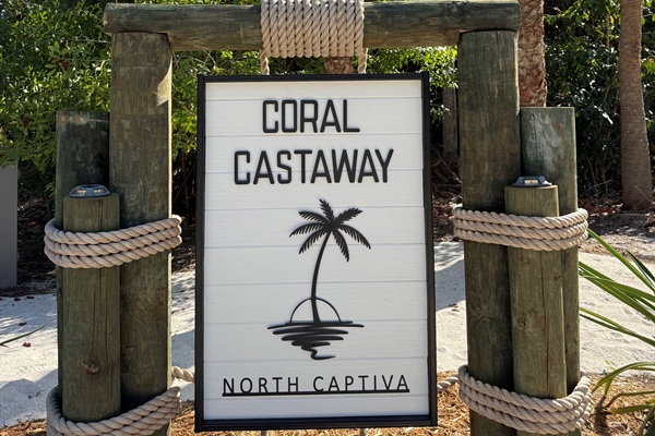 Let the Coral Castaway sign be your official invitation to make yourself at home