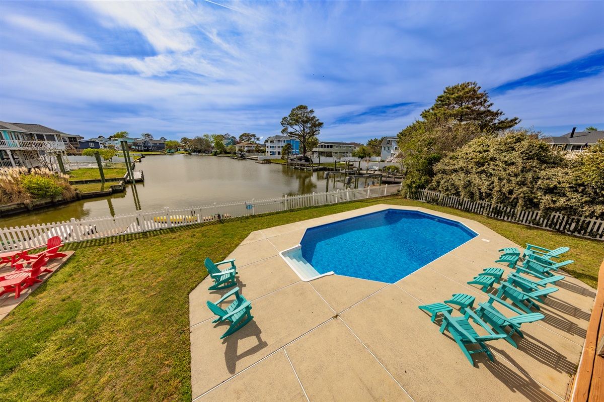 Enjoy poolside views of the Back Bay in this spacious waterfront home