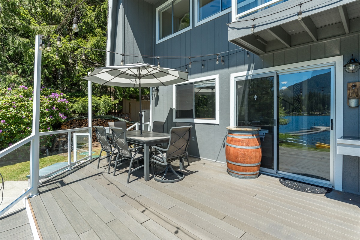 Main level deck with outdoor dining area, BBQ, and Blackstone Grill.