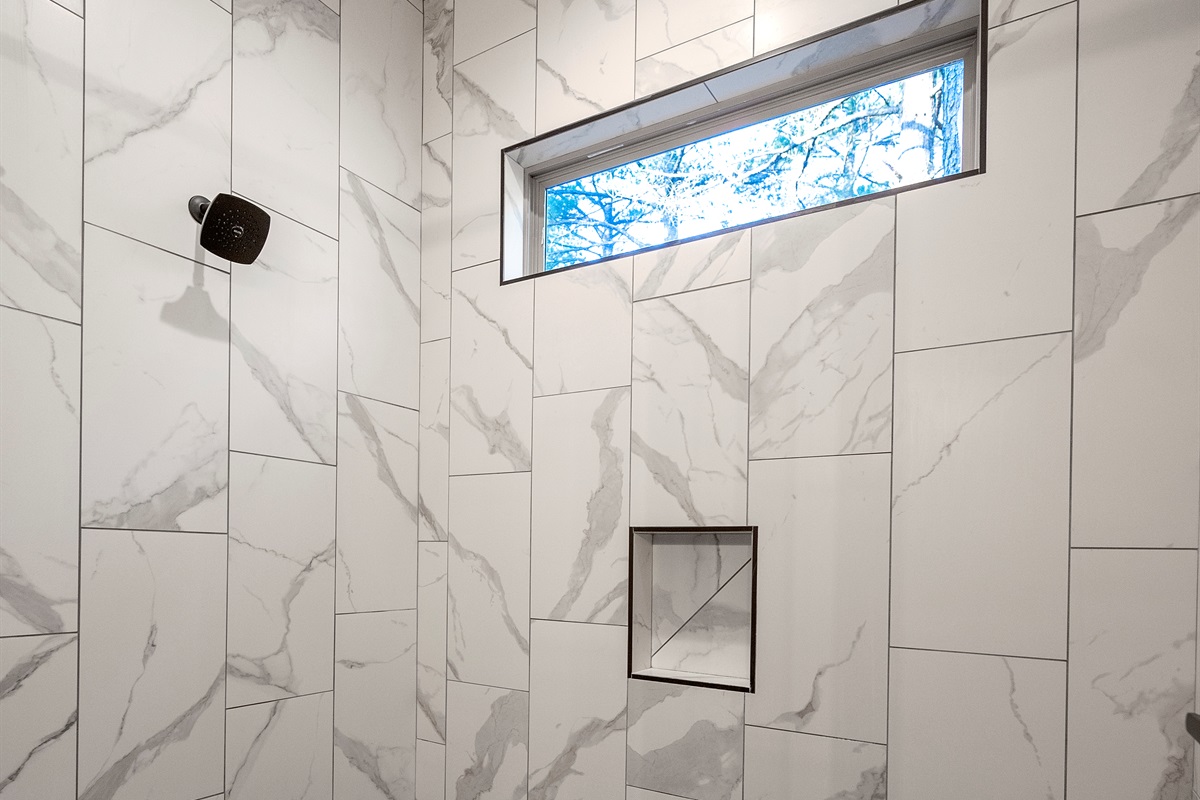 Refresh in the spa-inspired walk-in shower with beautiful tile and natural light.