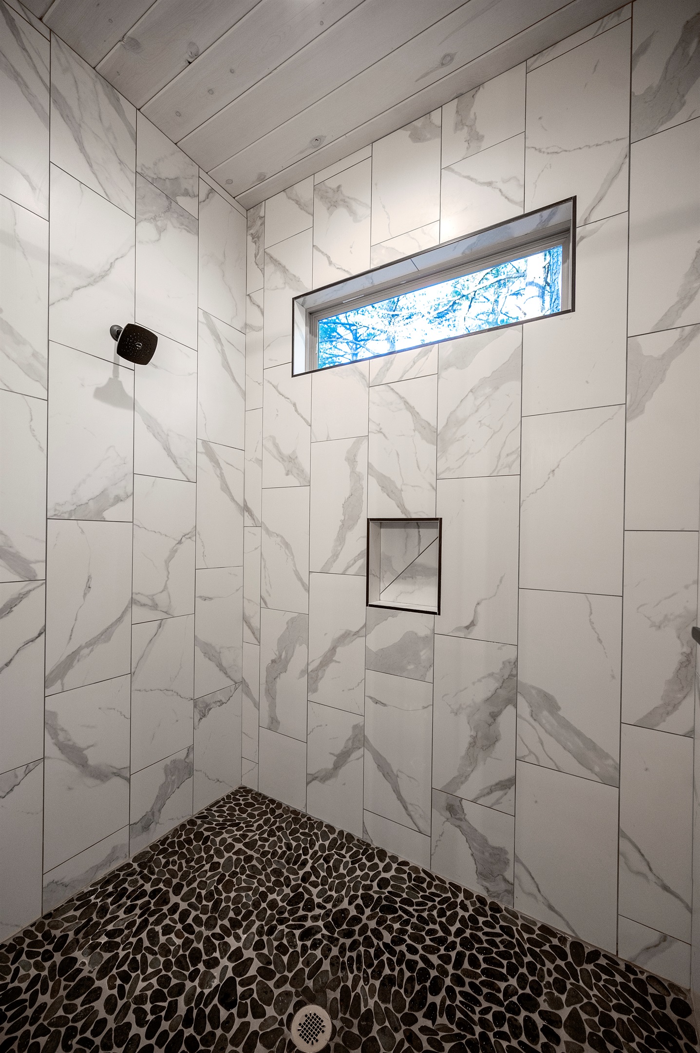 Refresh in the spa-inspired walk-in shower with beautiful tile and natural light.