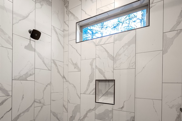Refresh in the spa-inspired walk-in shower with beautiful tile and natural light.