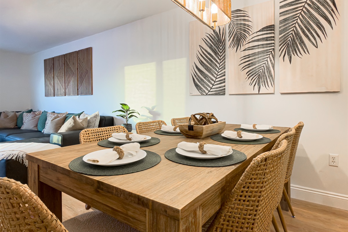 The large dining table seats seven comfortably for family meals. It is a great spot to gather after a day of exploring. Chat with the chef in the kitchen while setting the table. The open floor plan keeps everyone connected during your stay.