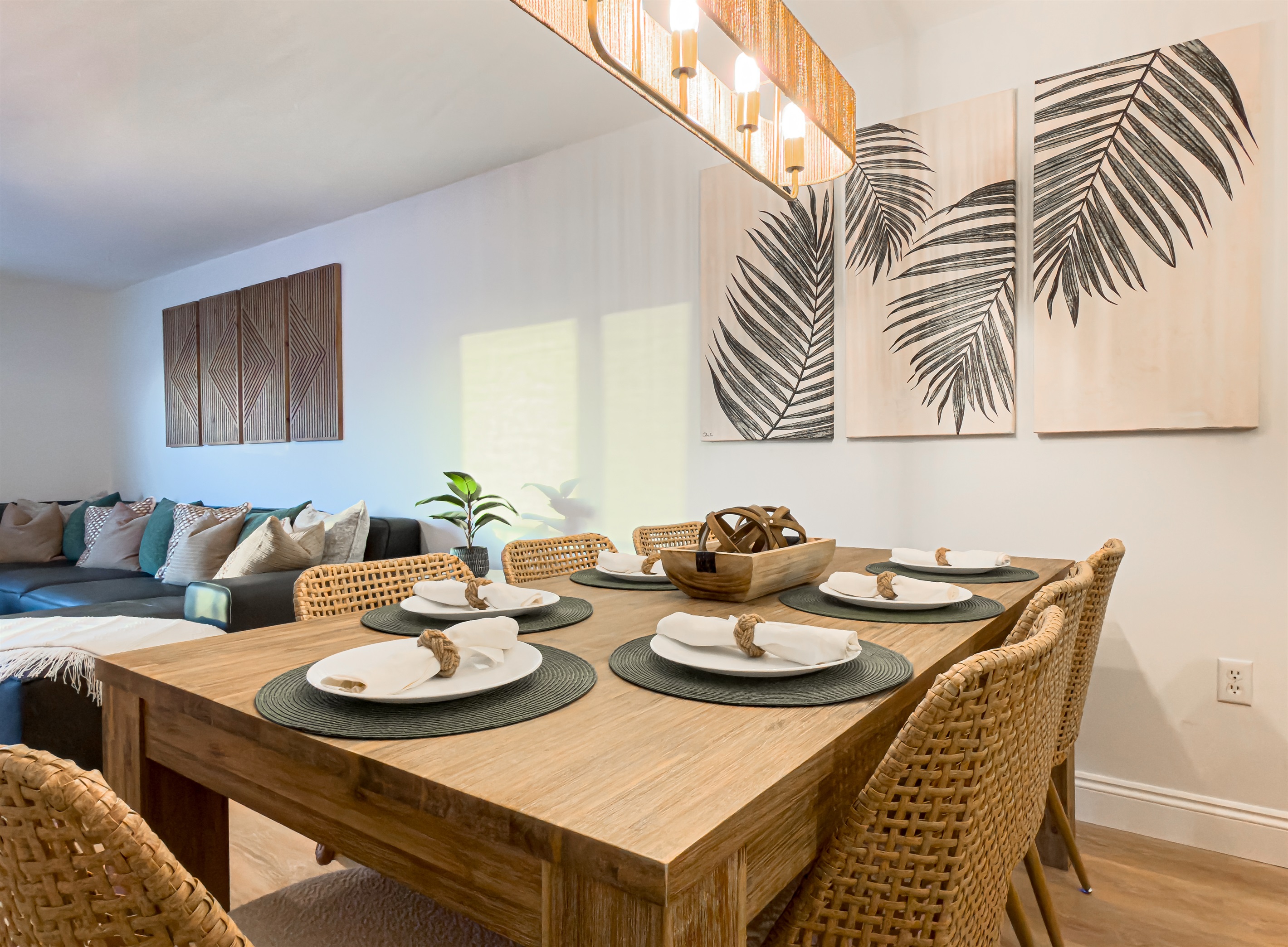 The large dining table seats seven comfortably for family meals. It is a great spot to gather after a day of exploring. Chat with the chef in the kitchen while setting the table. The open floor plan keeps everyone connected during your stay.