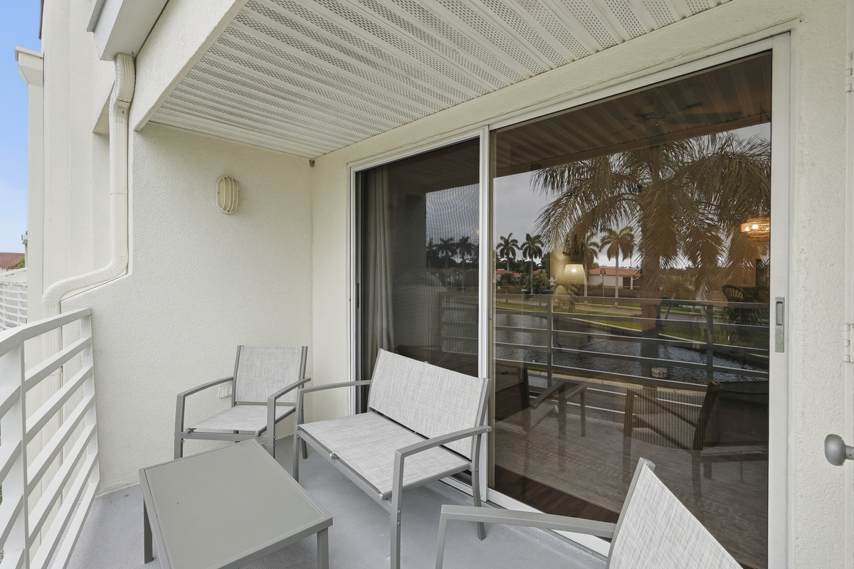 Step outside onto your private balcony and take in peaceful views of the water and the surrounding neighborhood. It's the perfect spot to enjoy your morning coffee, unwind with an evening drink, or simply soak in the beautiful Florida scenery.