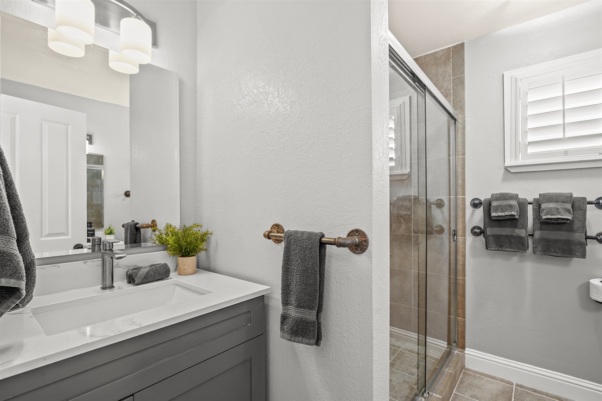 Private ensuite bathroom connected to the primary suite featuring dual sinks and a spacious layout.