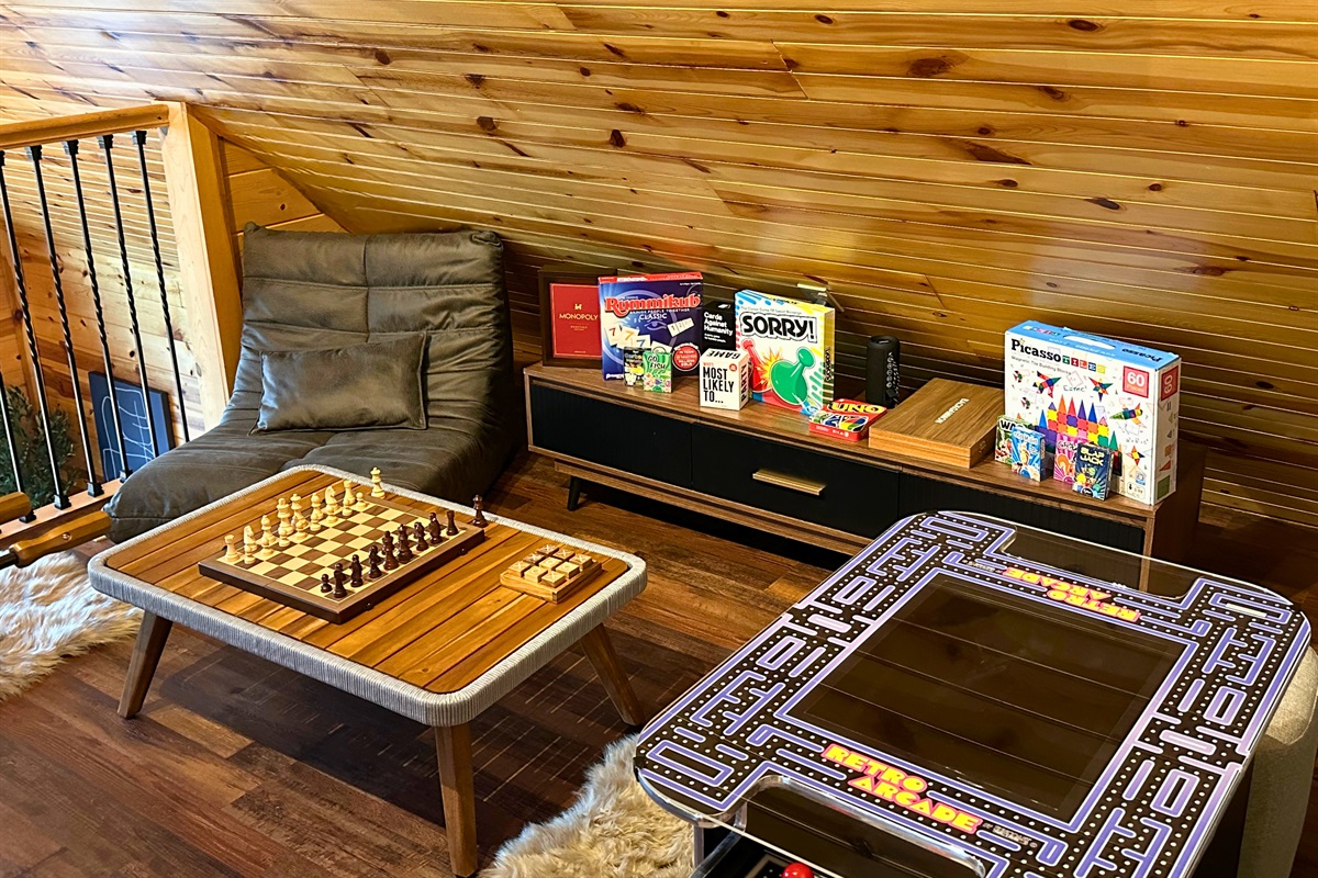 2nd floor: Step into the game room at Signature Stay, featuring arcade games, and a variety of board and card games for endless family fun