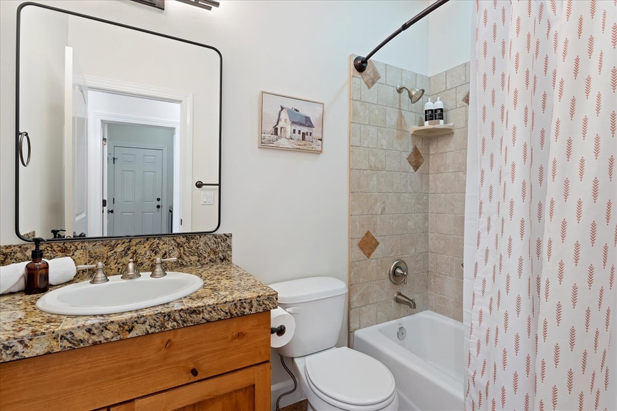 A full bathroom with a tub/shower combo and clean, modern finishes—everything you need for a comfortable stay.