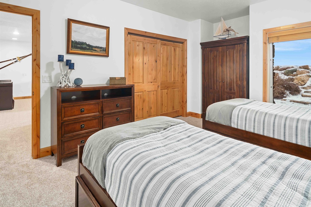 Bright bedroom with comfortable bedding and ample storage.