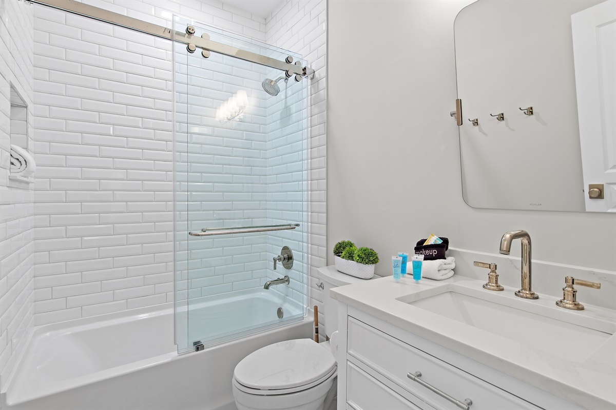 Clean, modern bathroom with tub and shower combo