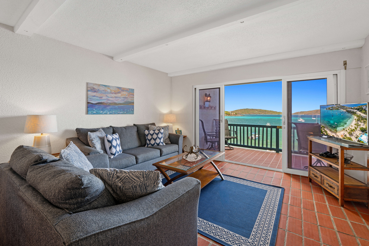 Relax in the inviting living space with beautiful views just beyond the balcony.