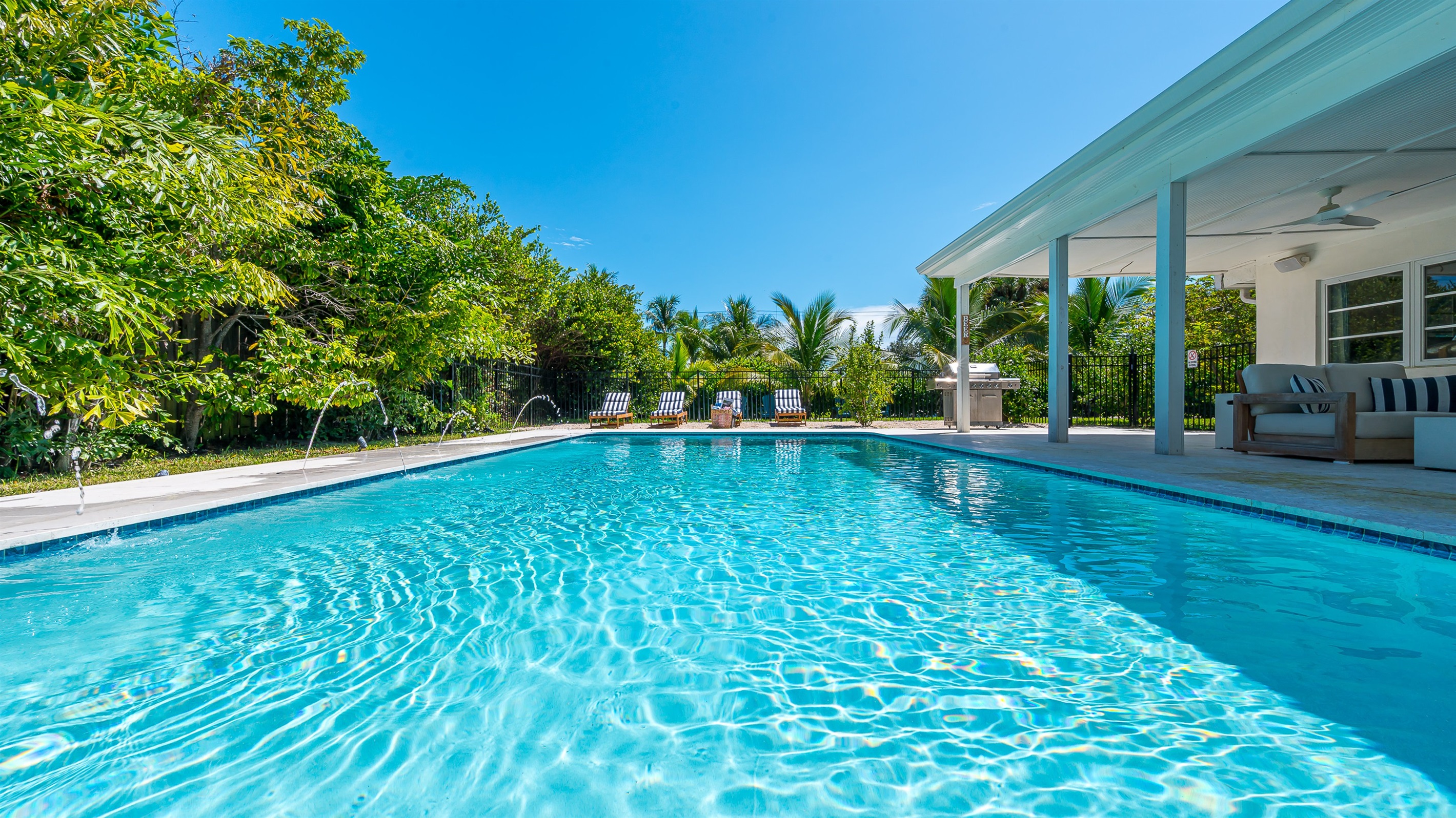 Heated saltwater pool with deck jets and color-changing LED lights. Perfect spot to soak up the sunshine and take a dip any time of day.