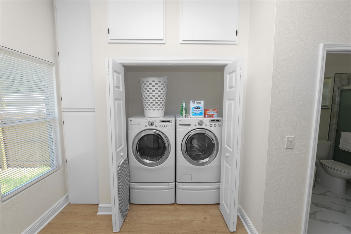 A dedicated laundry space with front-loading machines, bright lighting, and starter detergent provided to keep you feeling fresh throughout your stay.