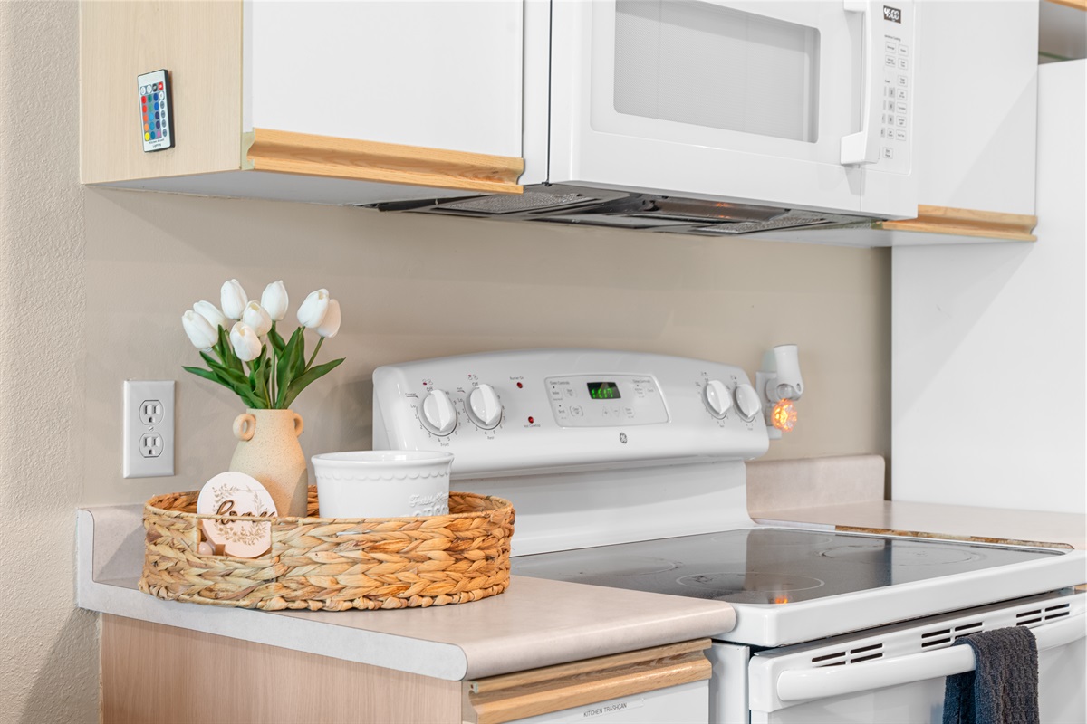 Kitchen detail shot highlights the clean appliances and ready-to-use cooking setup.