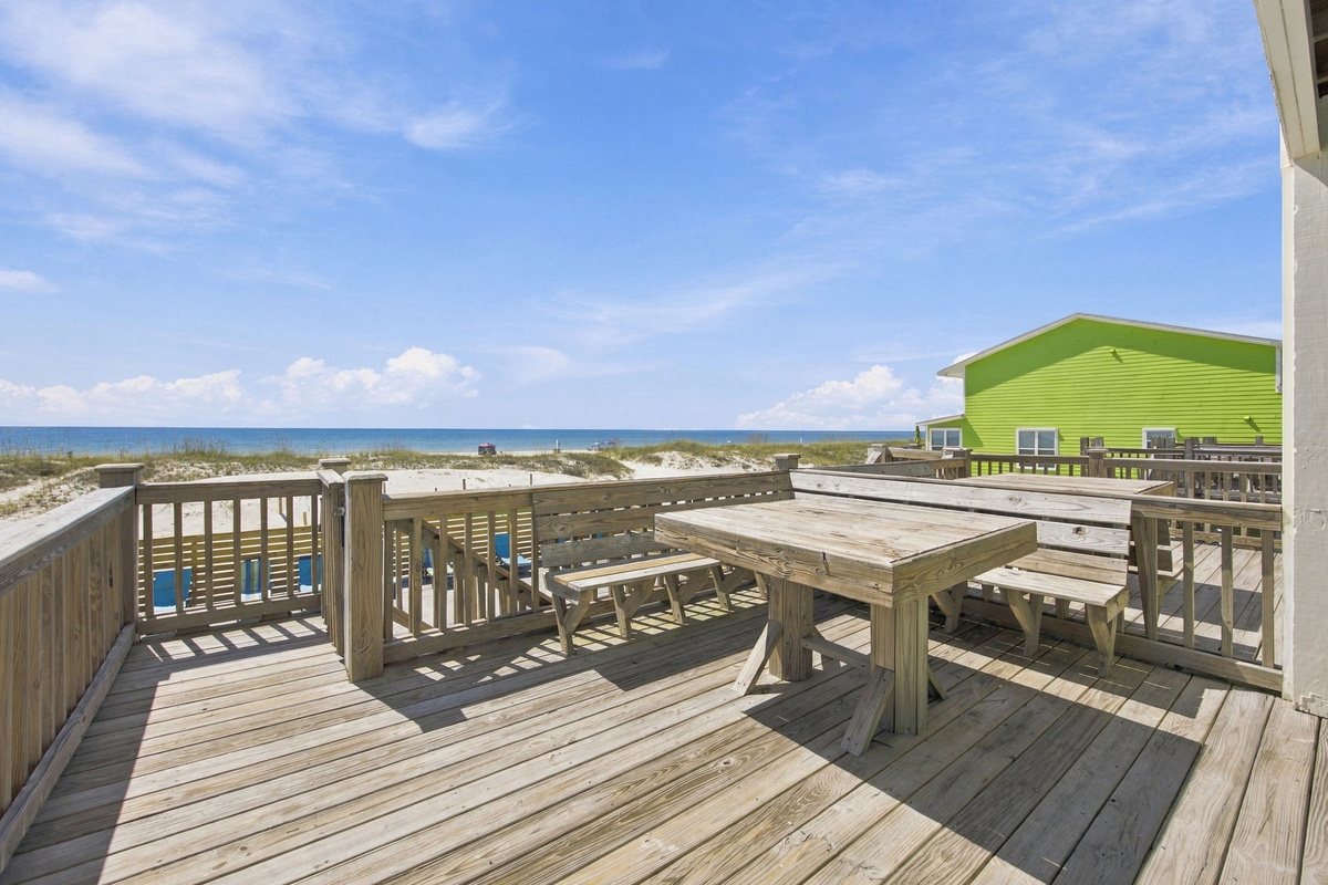 Spacious elevated outdoor deck with dining table and seating, offering a relaxing setting for outdoor meals and coastal views.Spacious elevated outdoor deck with dining table and seating, offering a relaxing setting for outdoor meals and coastal views.