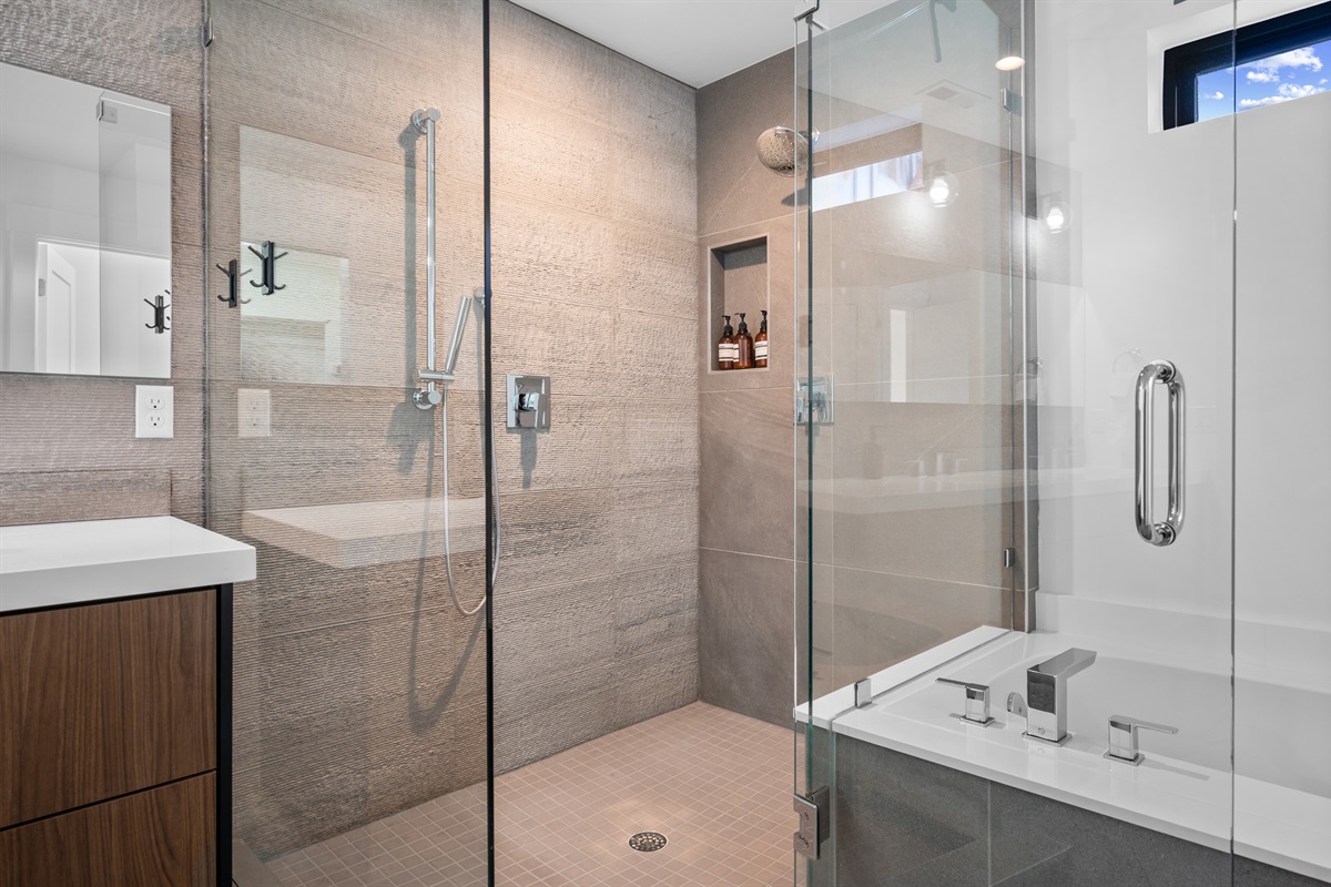 Luxurious glass-enclosed shower with designer tile and premium fixtures.