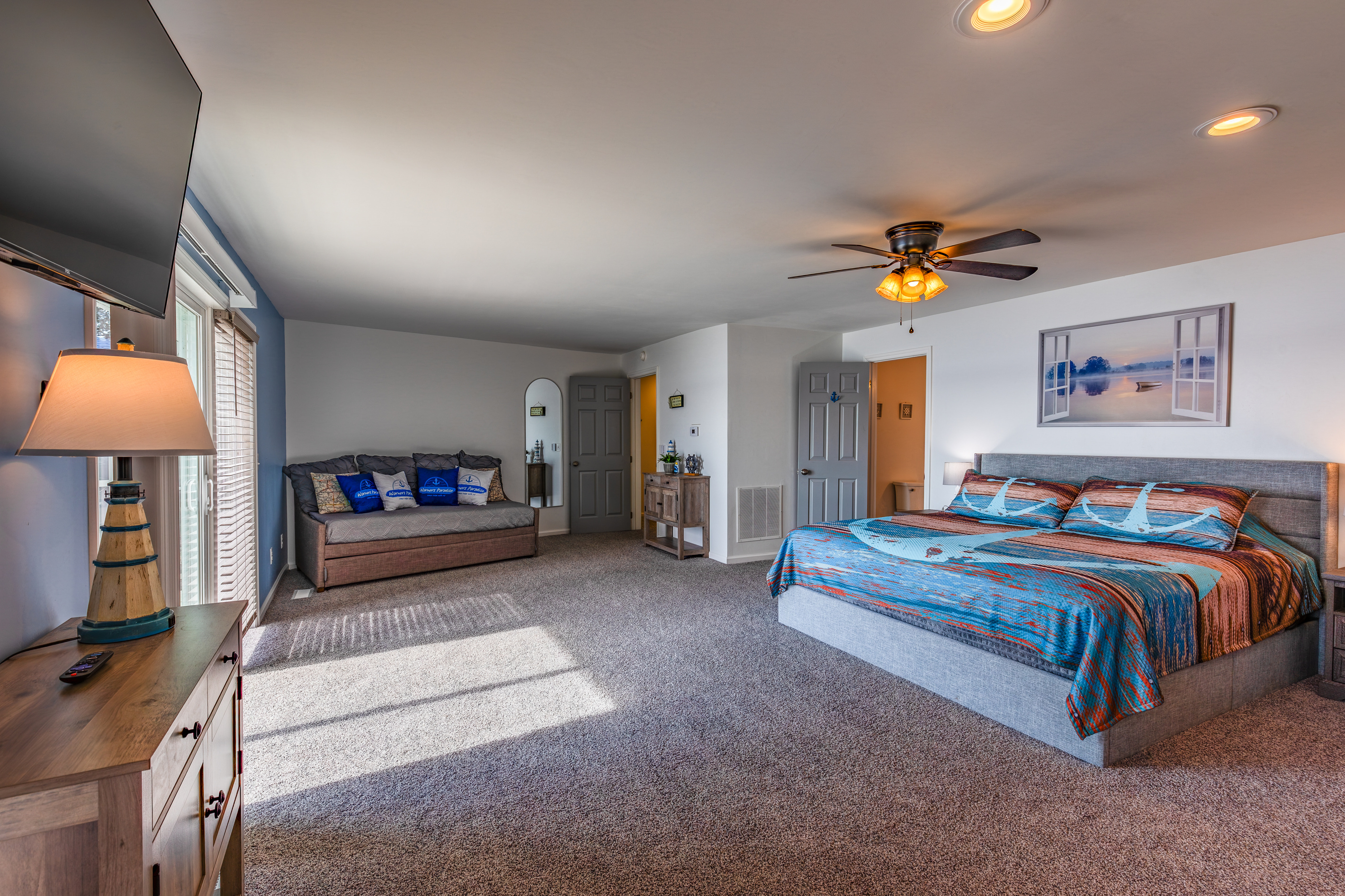 Another wide view of the king suite shows its sitting area, fireplace, and spacious layout.