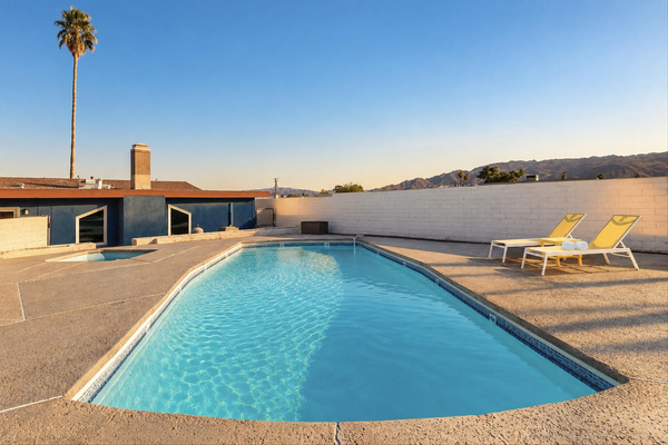 Private pool framed by desert mountain views, with sun loungers for long afternoons