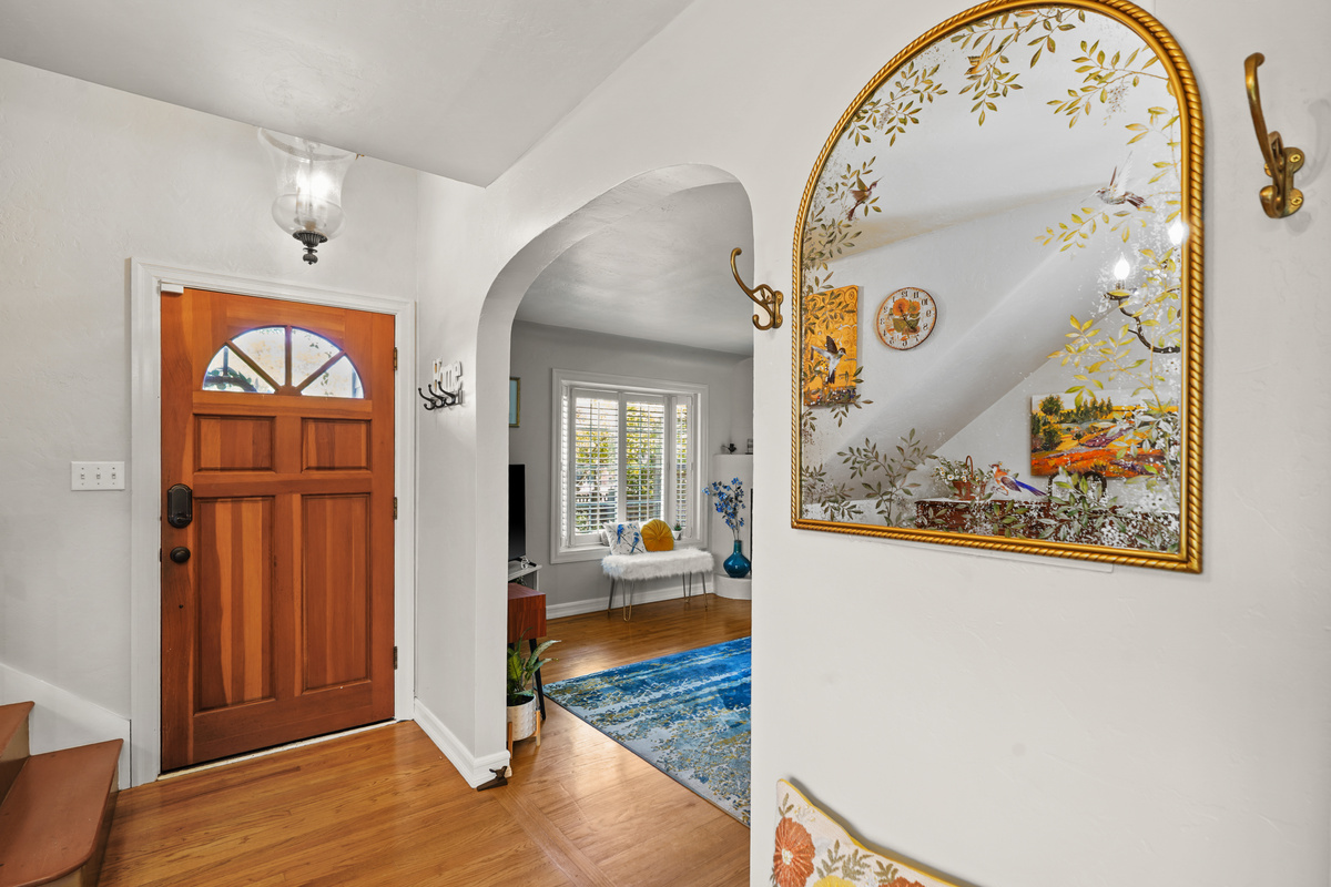 Charming entryway with coat hooks, mirrors, and a bench for easy arrivals and departures.