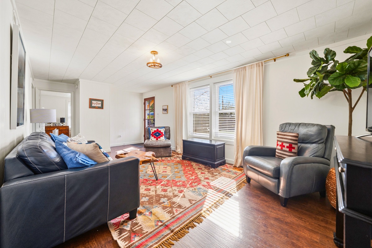 Relax in the guest house living space where comfortable seating and natural light combine to create a laid-back, inviting atmosphere.