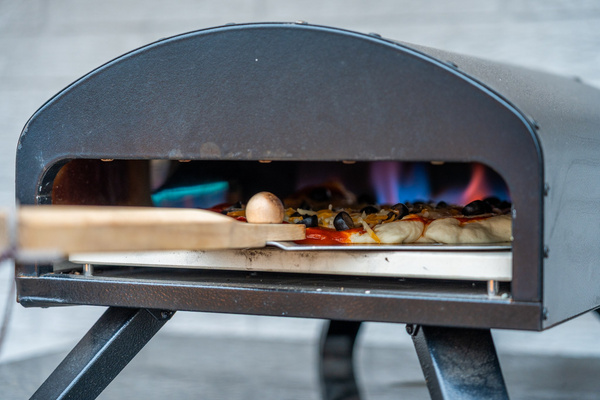 Slide a pizza into the wood-fired oven — Hot Springs Breakaway