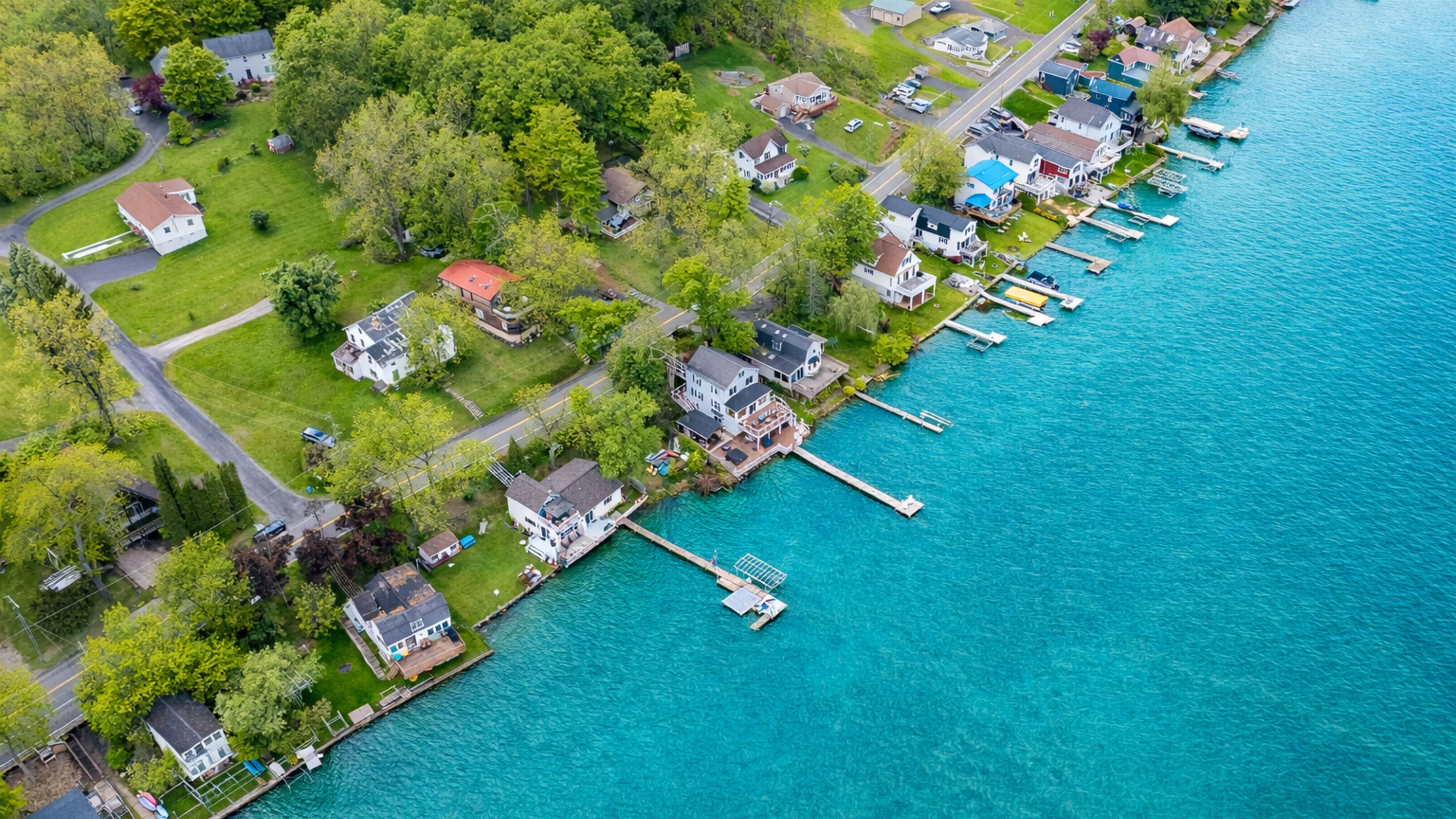 Aerial shot showcasing expansive lakefront entertaining space, hot tub, and private dock for the ultimate getaway 🎯🌊🍹