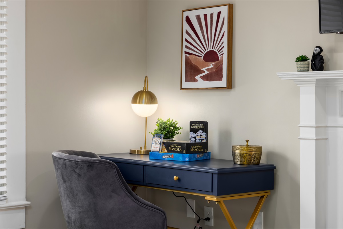 Work Hard, Play Hard: Our living room features a dedicated workspace amidst a treasure trove of games – the perfect balance.