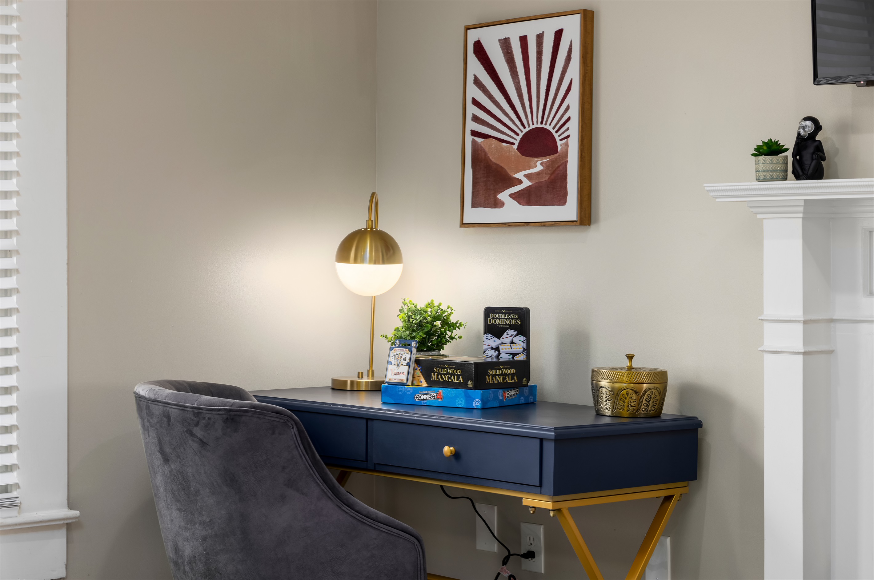 Work Hard, Play Hard: Our living room features a dedicated workspace amidst a treasure trove of games – the perfect balance.