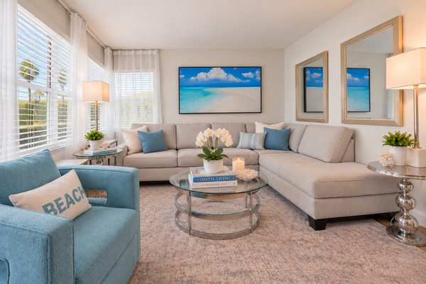 Bright coastal living room with comfortable seating and a relaxed, airy feel.